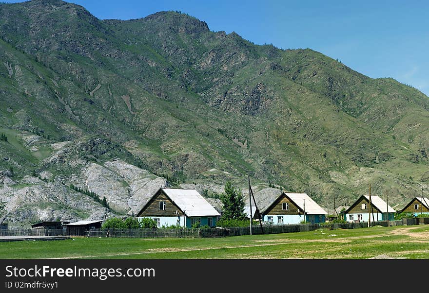 The mountain river flows among vegetation. The mountain river flows among vegetation