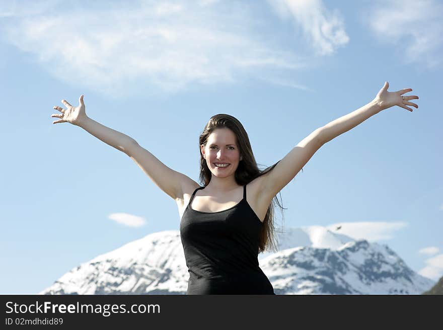 Woman hiker raising up her arms in the air on a mountain after. Woman hiker raising up her arms in the air on a mountain after