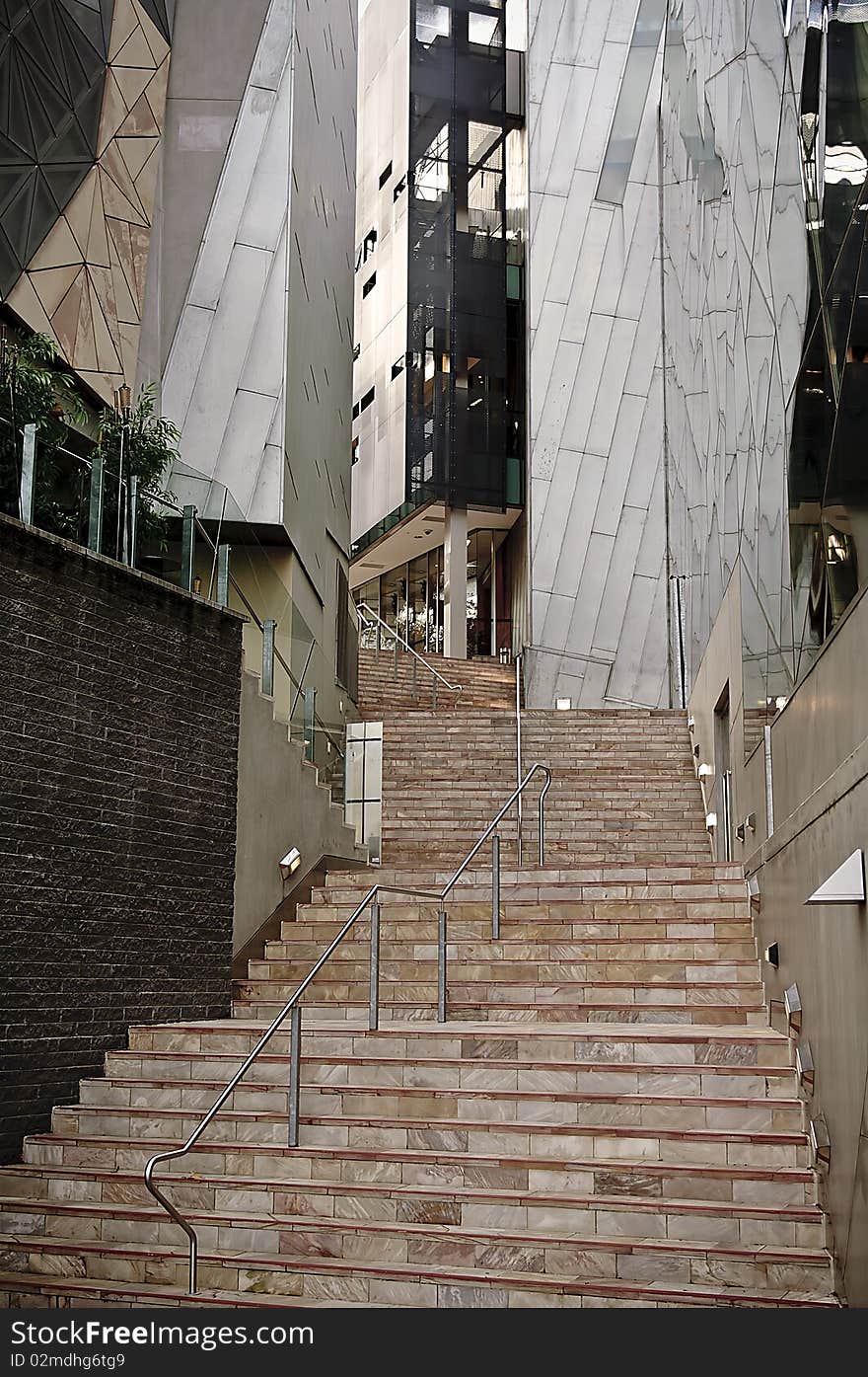 Steps in a city leading between modern buildings. Steps in a city leading between modern buildings