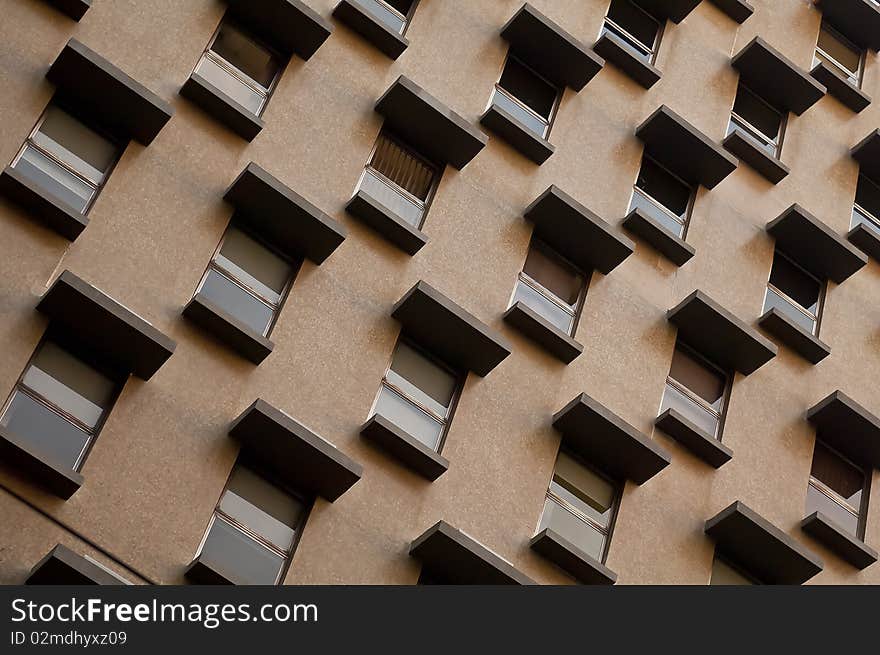 Rows of identical windows in a retro city apartment wall. Rows of identical windows in a retro city apartment wall.