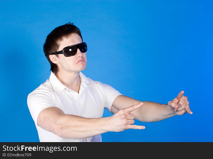 Brave guy in the studio against a blue background