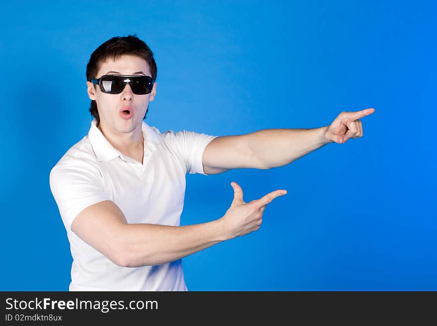 Surprised a guy with glasses on a blue background. Surprised a guy with glasses on a blue background