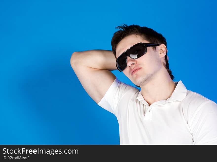 Portrait of a brave guy in the studio against a blue background. Portrait of a brave guy in the studio against a blue background