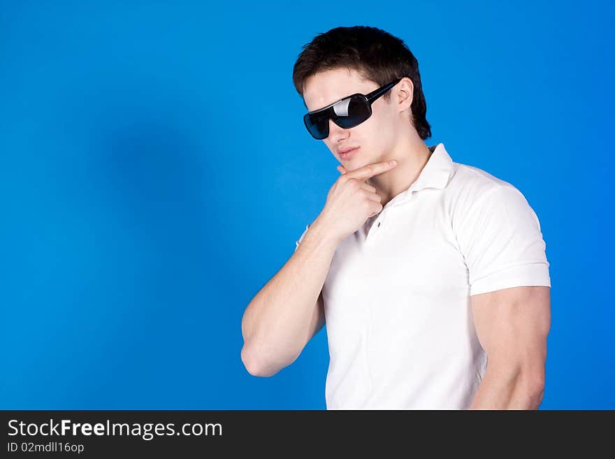 Confident guy with the glasses in the studio