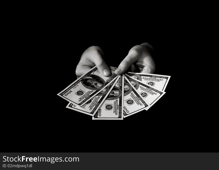 Hands with dollars over black