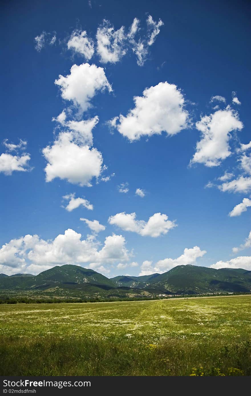 Summer landscape with blue sky, clouds and green color nature