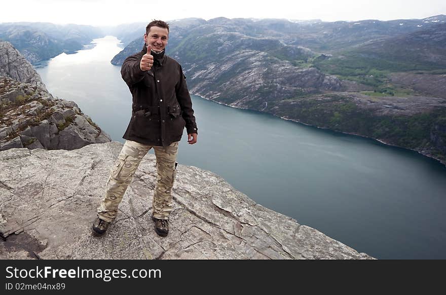 Man is happy after arrived the peak of a mountain. Man is happy after arrived the peak of a mountain