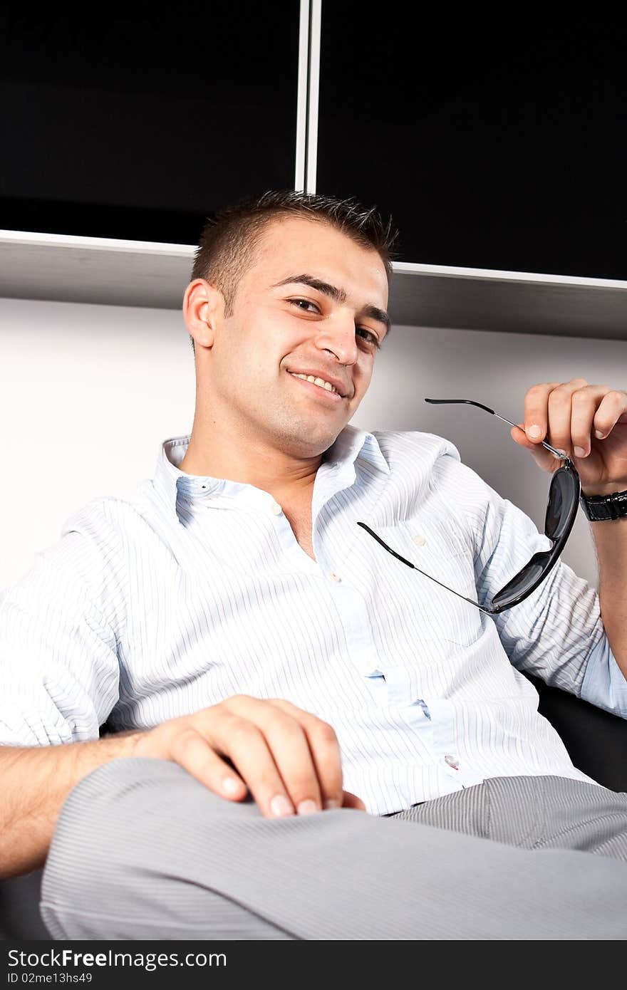 Young man with sunglasses sitting down