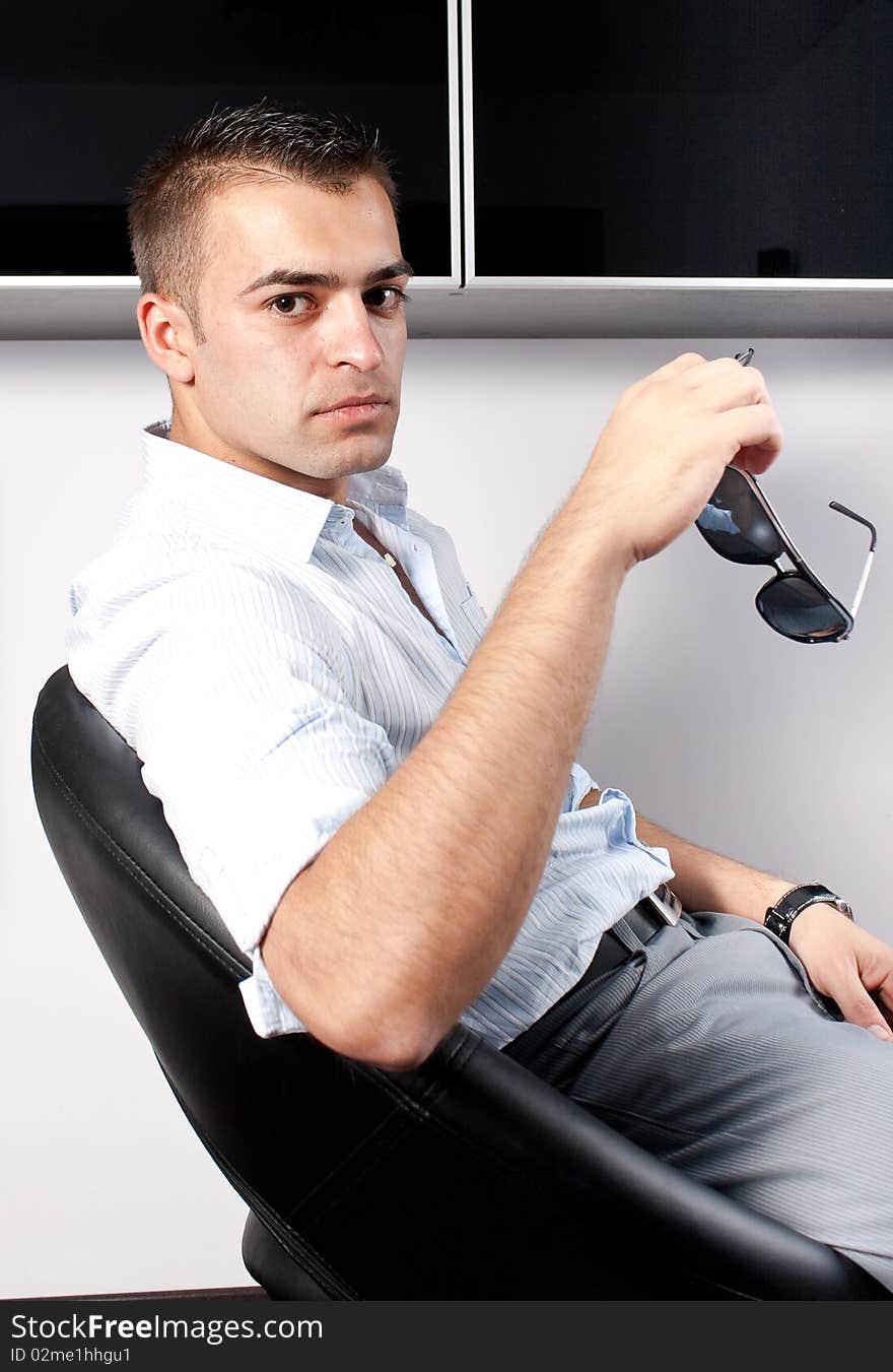 Young man with sunglasses sitting