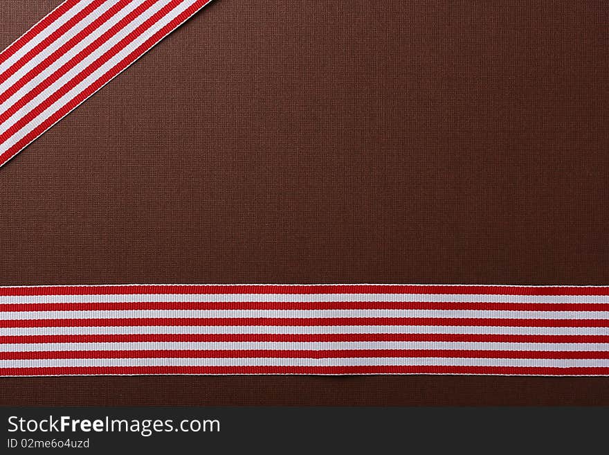 Brown background with two red-white tapes for design works.