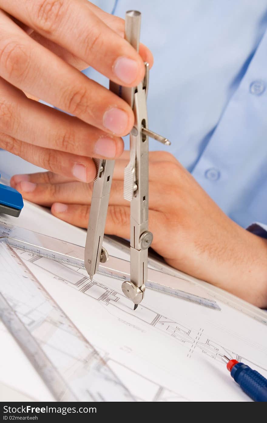 Architect working on architectural plans in the office