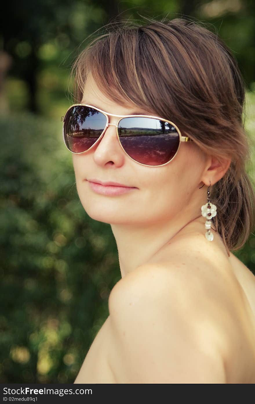 Young woman outside wearing sunglasses