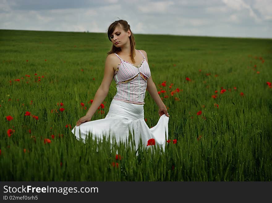 Beautiful young woman and poppies