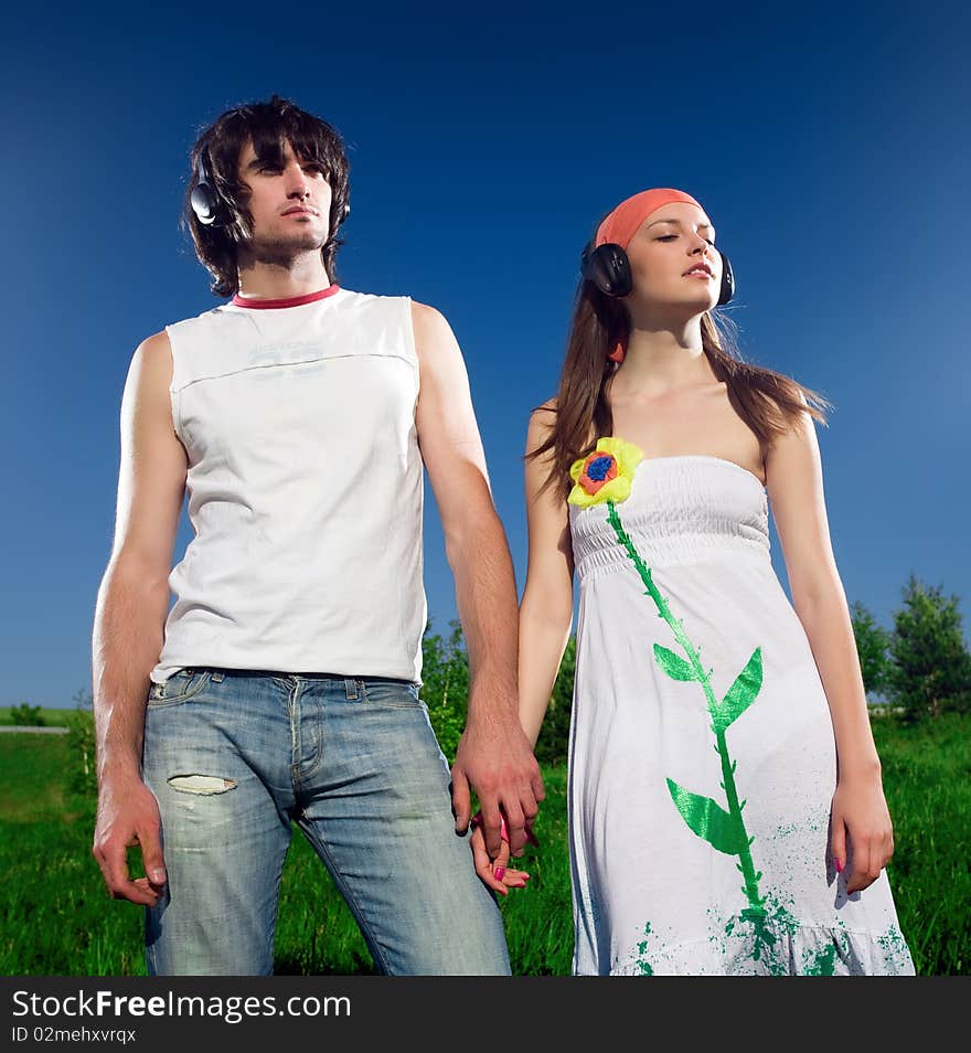 Boy with long-haired girl in headphones. Boy with long-haired girl in headphones