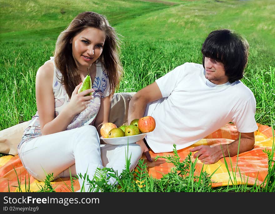 Long-haired girl with fruits and boy