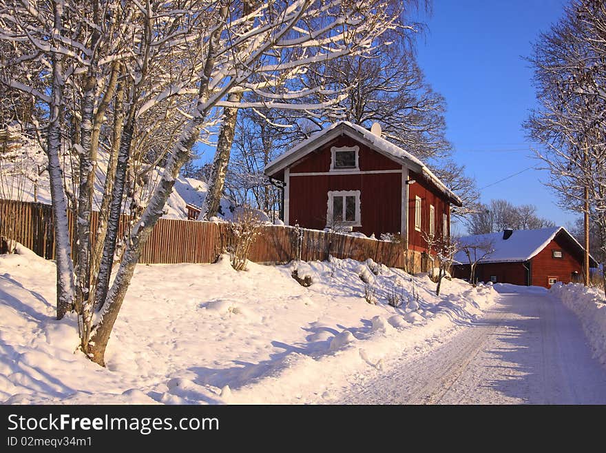 An old village in winter, snow and blue sky. An old village in winter, snow and blue sky.