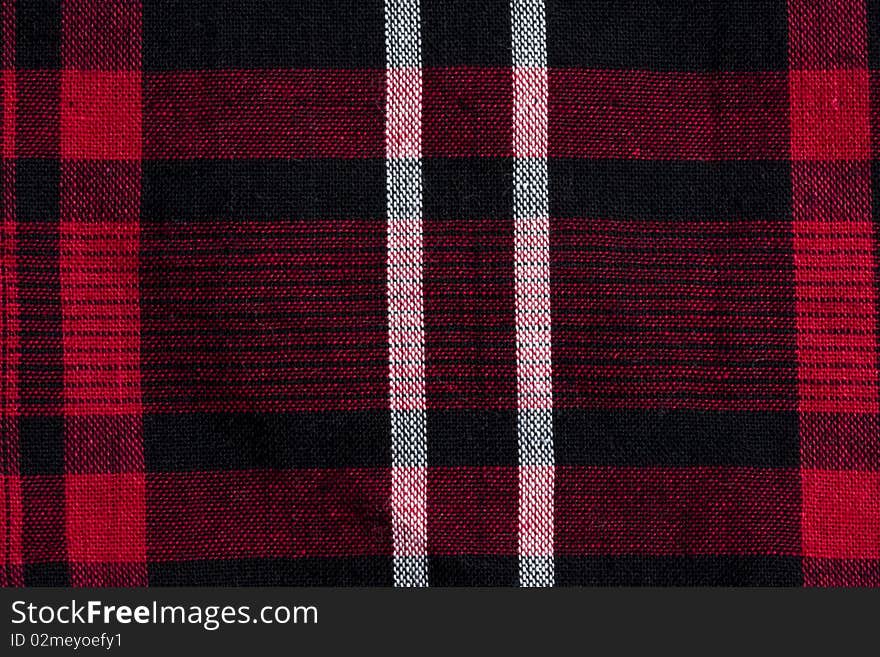 Texture of red-black checkered fabric pattern background