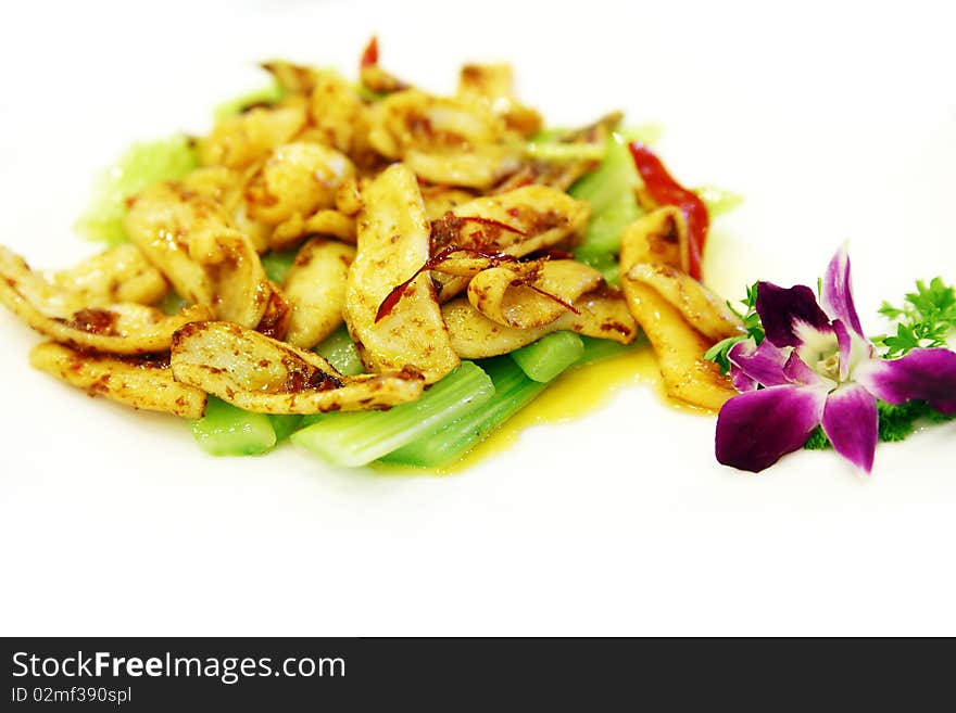 Chinese food on the table.Cooked squid with celery.