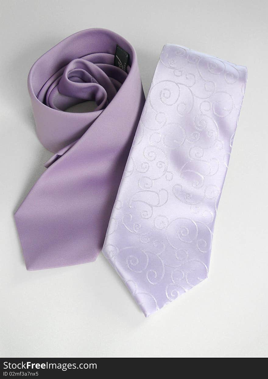 Two lila tie on gray background