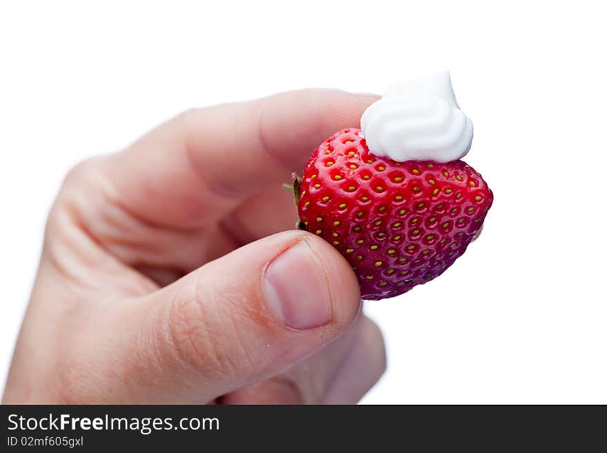 Strawberry with cream in hand isolated on white