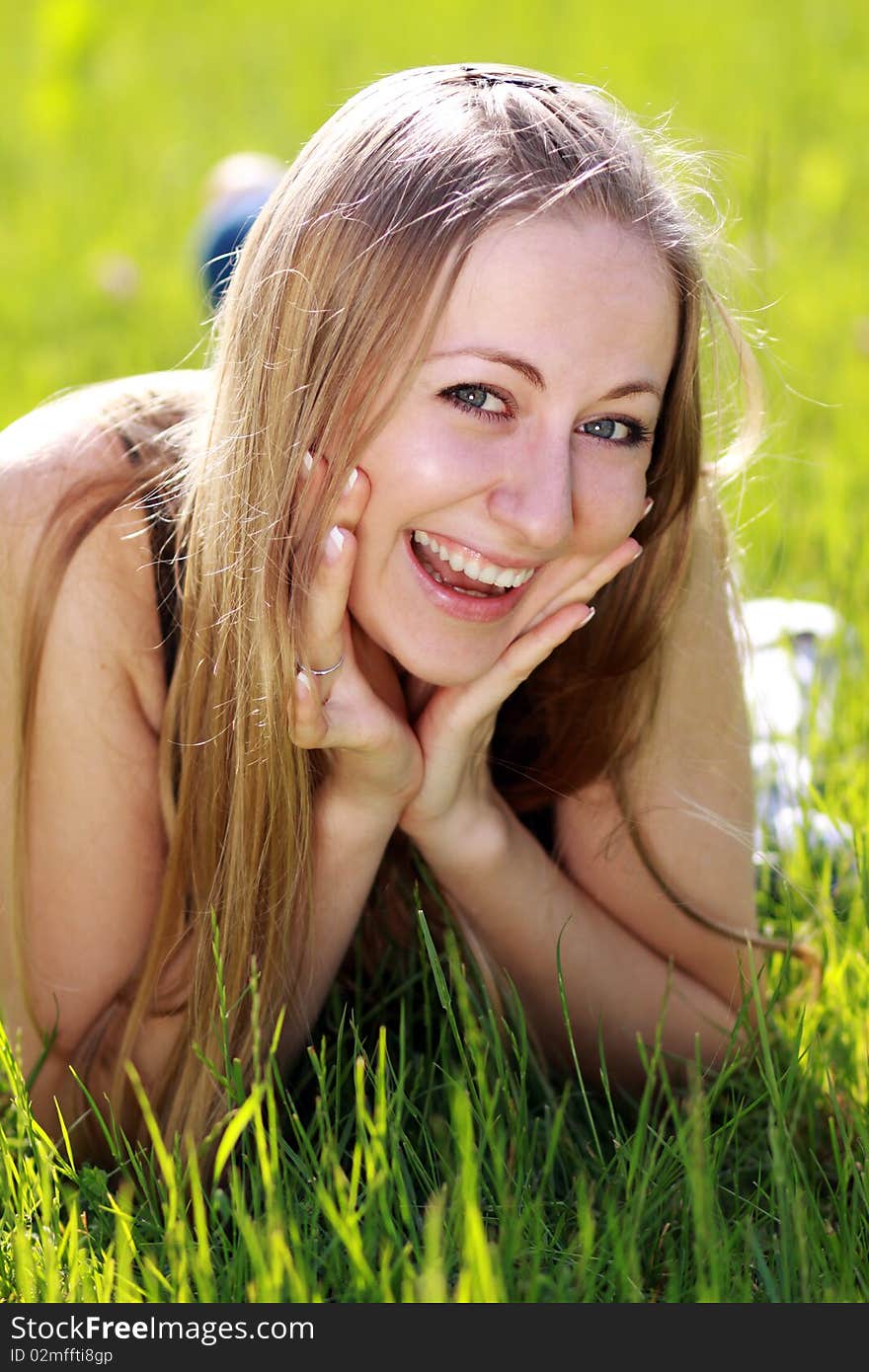 Happy Woman On The Green Grass