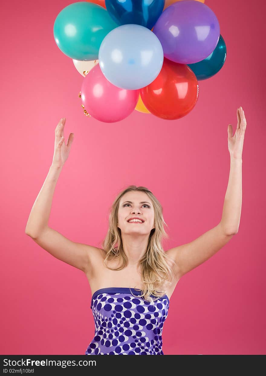 Pretty woman with colorful balloons on pink background. Pretty woman with colorful balloons on pink background