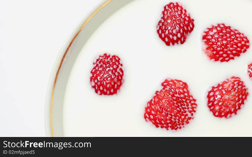 Strawberries in milk isolated on a white background. Strawberries in milk isolated on a white background