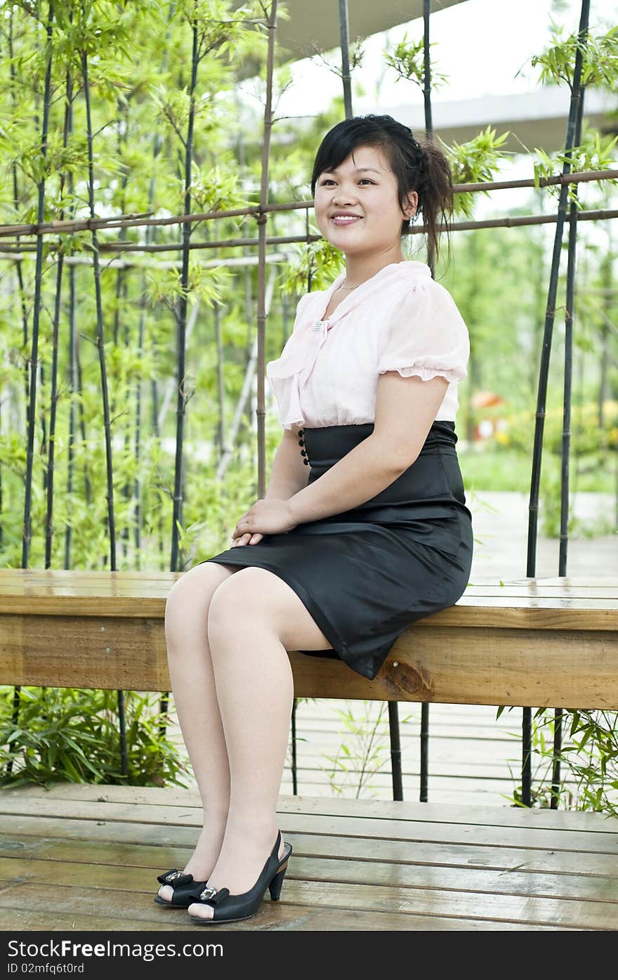 A Chinese business women, shoot in a garden. A Chinese business women, shoot in a garden