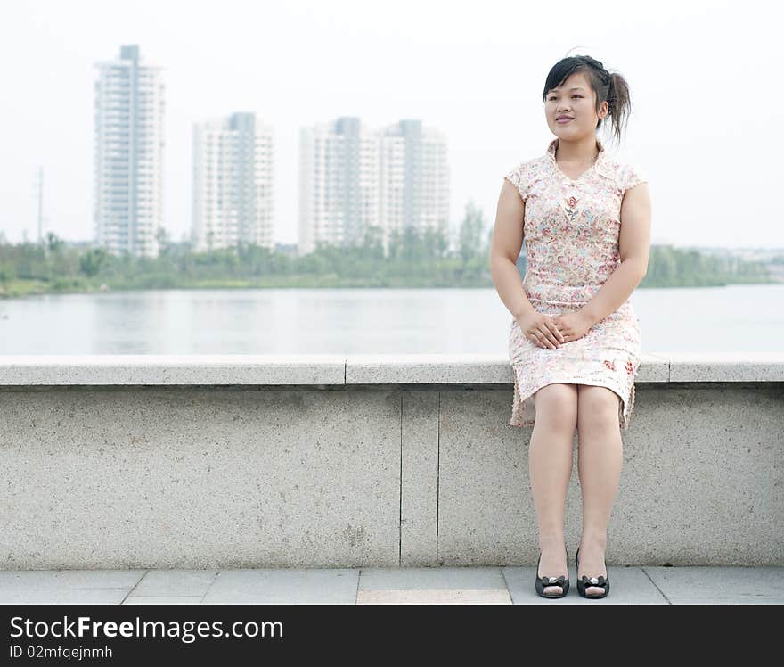 A Chinese business woman, shoot in a garden. A Chinese business woman, shoot in a garden