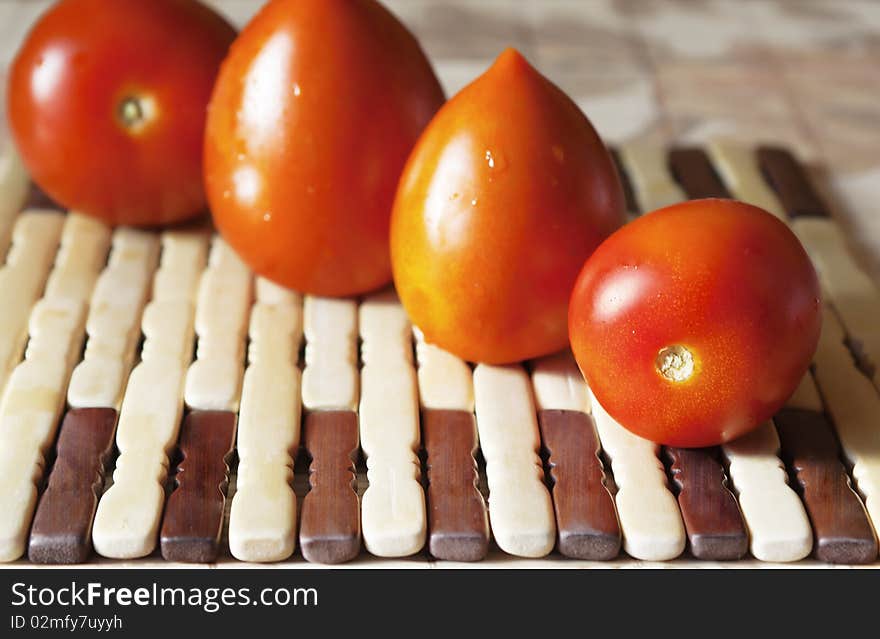 Red tomatoes on wooden decorative plates