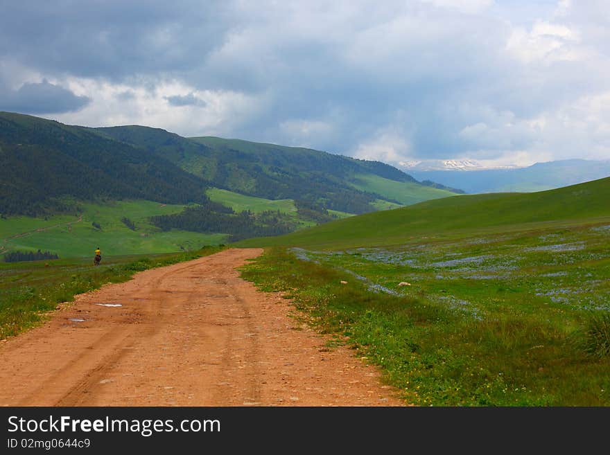 The shepherd on a horse in mountains