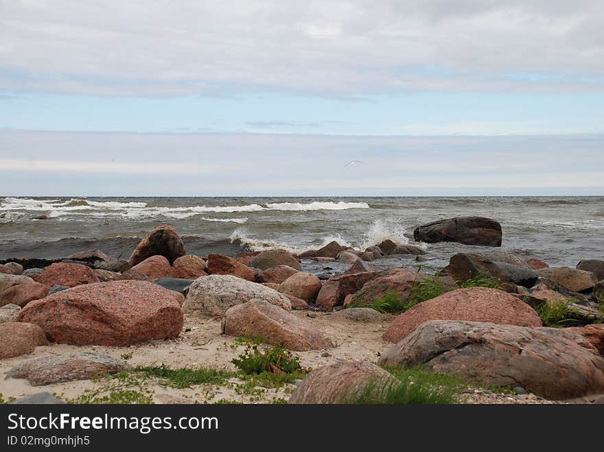 Stones on a beach with cloudy sky. Stones on a beach with cloudy sky