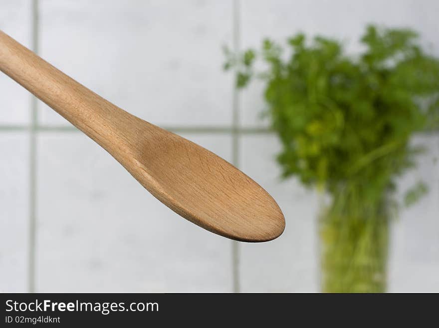 Wooden spoon and parsley in background. Wooden spoon and parsley in background