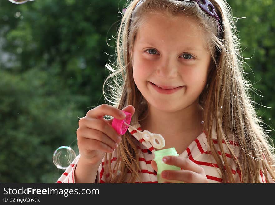 An image of a nice girl making bubbles. An image of a nice girl making bubbles