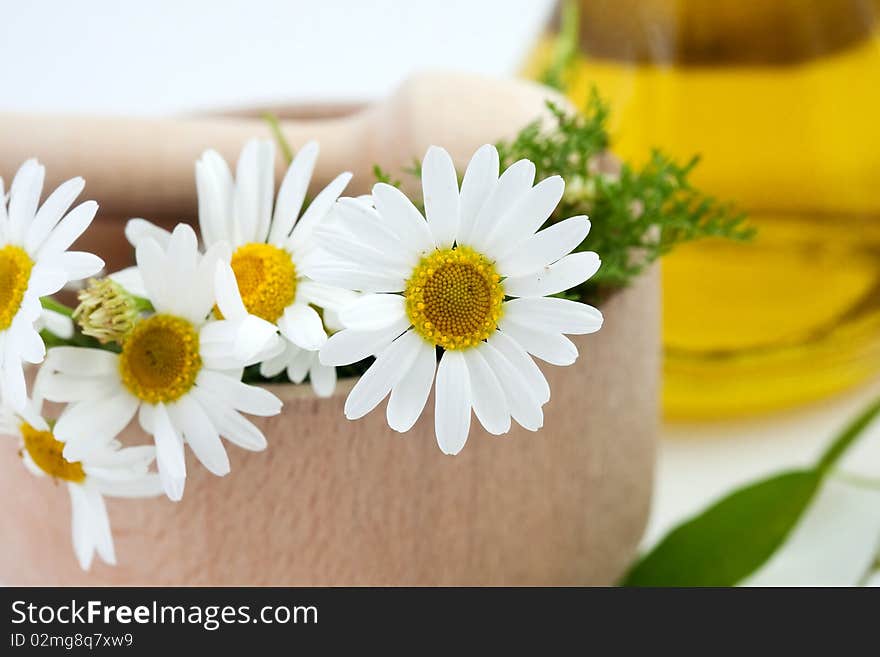 An image of white flowers in wooden mortar