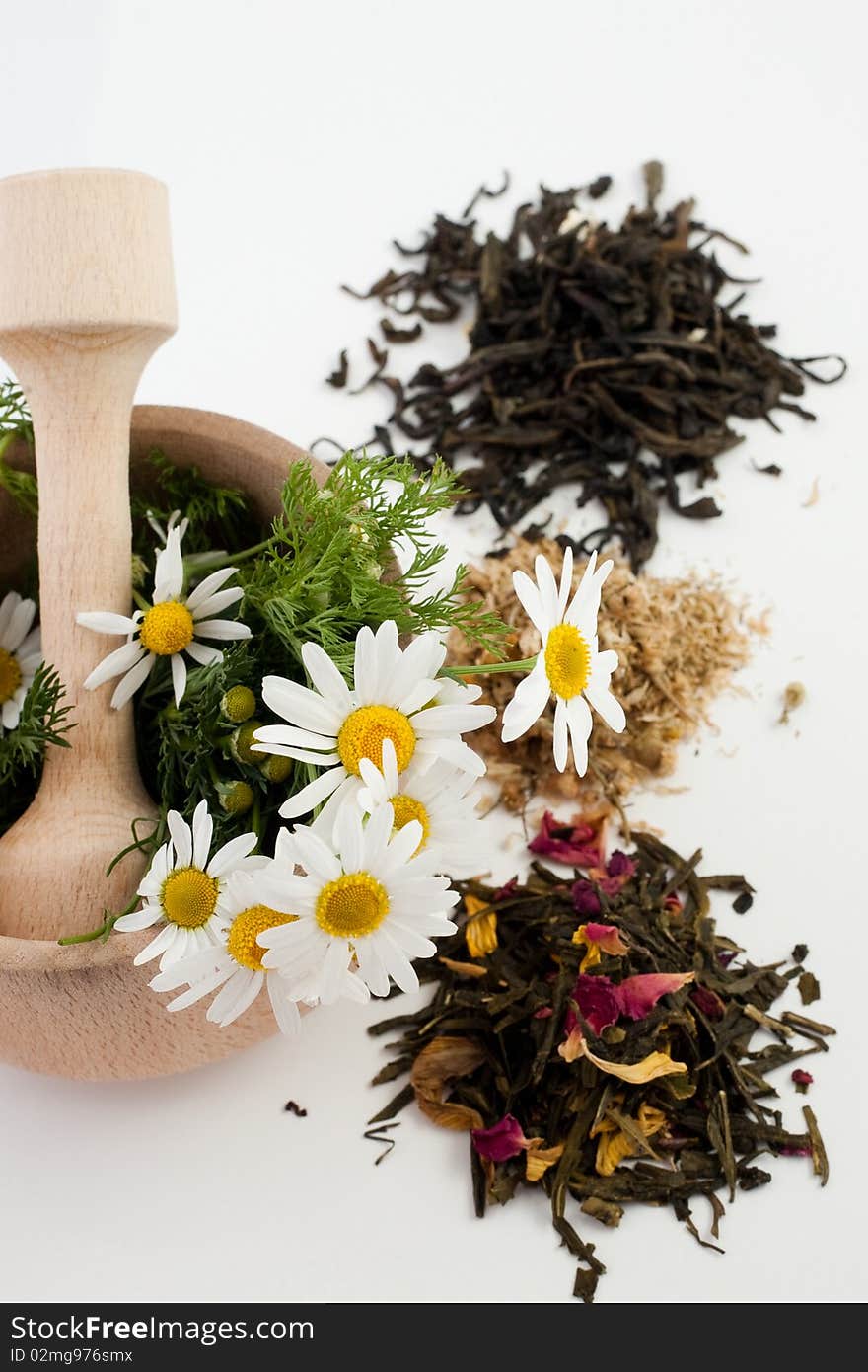 An image of mortar with flowers and tea. An image of mortar with flowers and tea