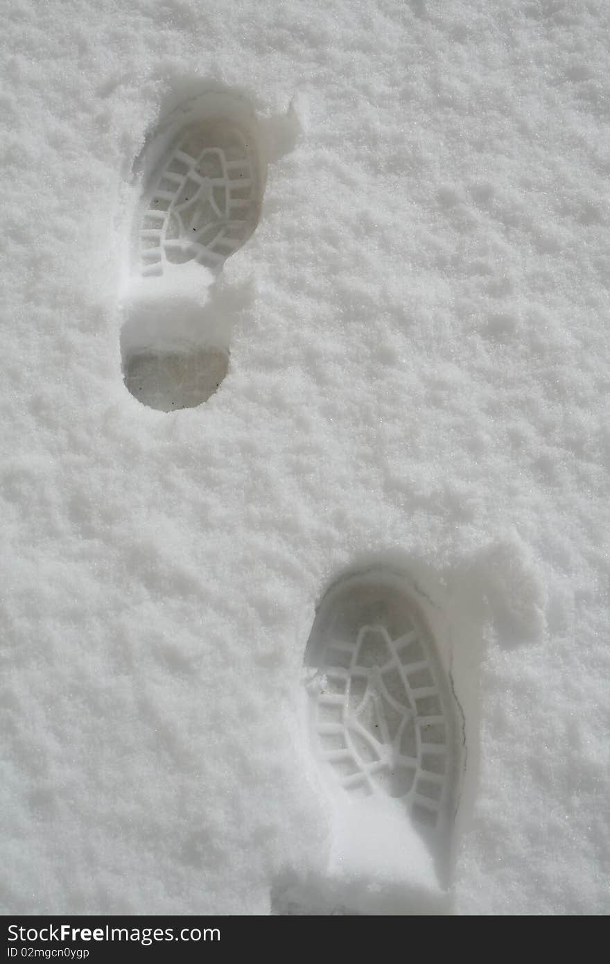 Two shoe marks in the snow. Two shoe marks in the snow