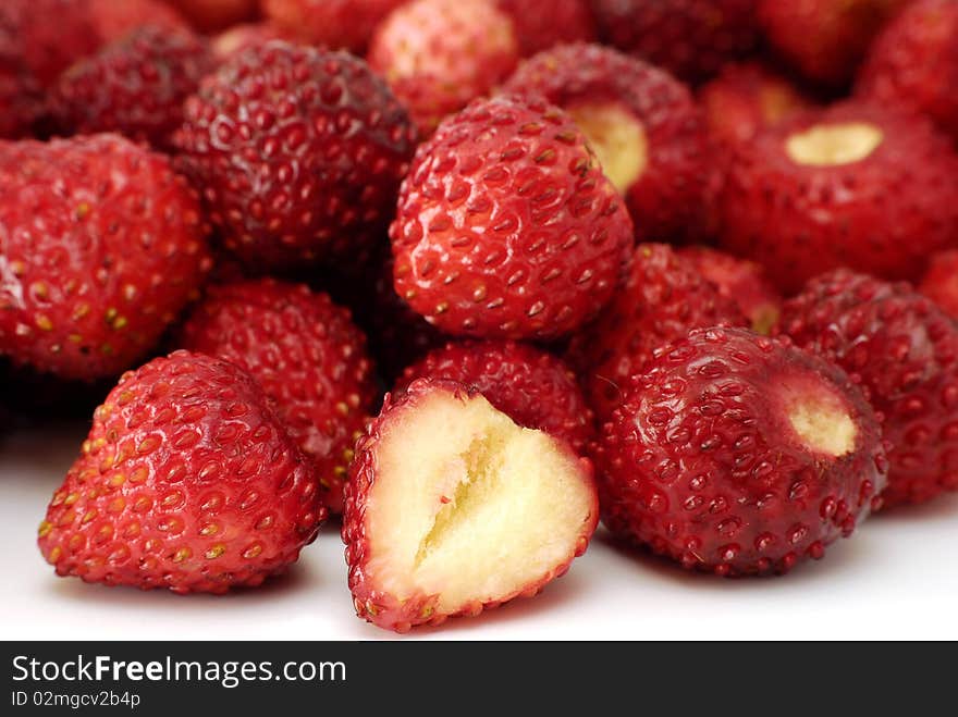 Wild strawberries made out on the white background. Wild strawberries made out on the white background