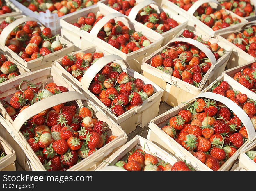 Ripe strawberries with leaves in baskets. Ripe strawberries with leaves in baskets