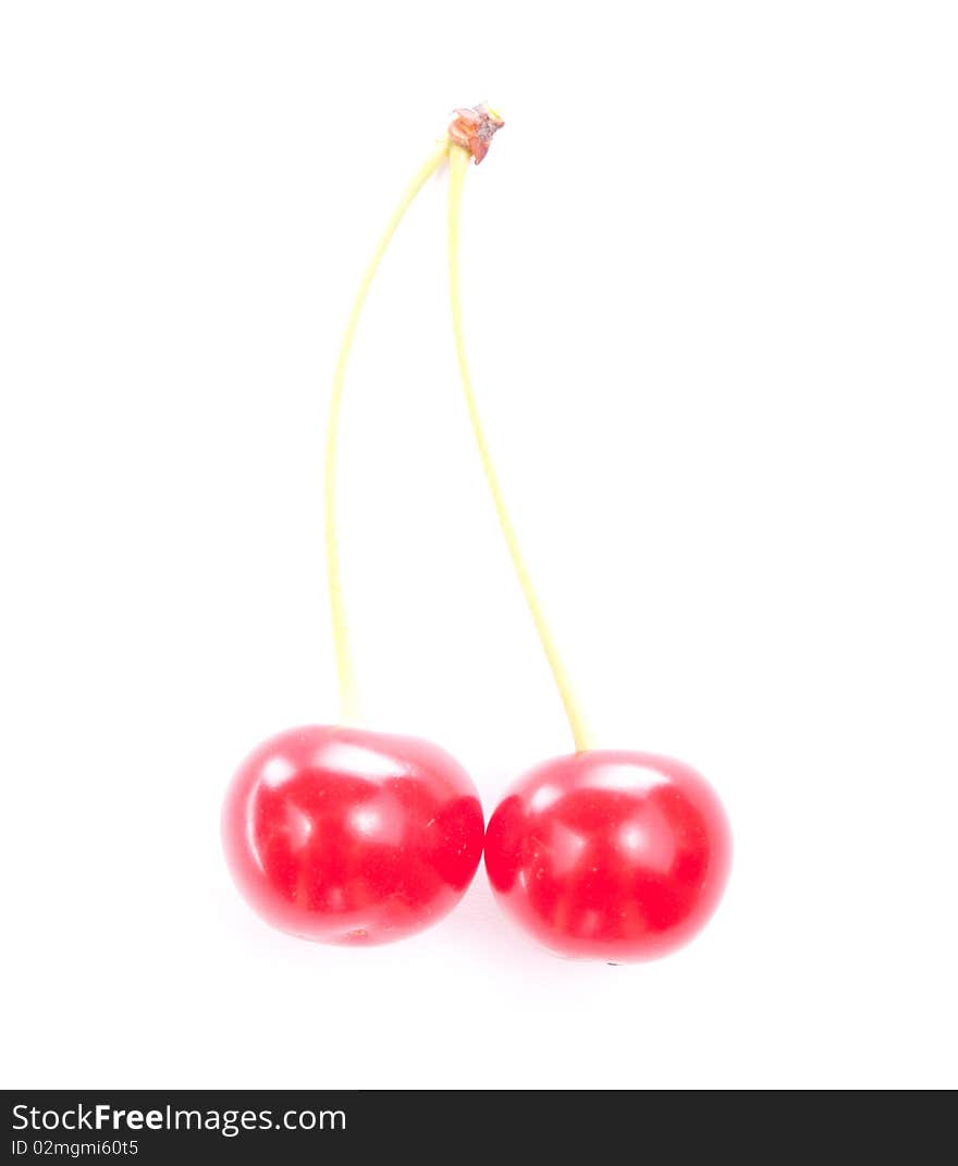 Two colorful red cherries isolated on white background. Two colorful red cherries isolated on white background.