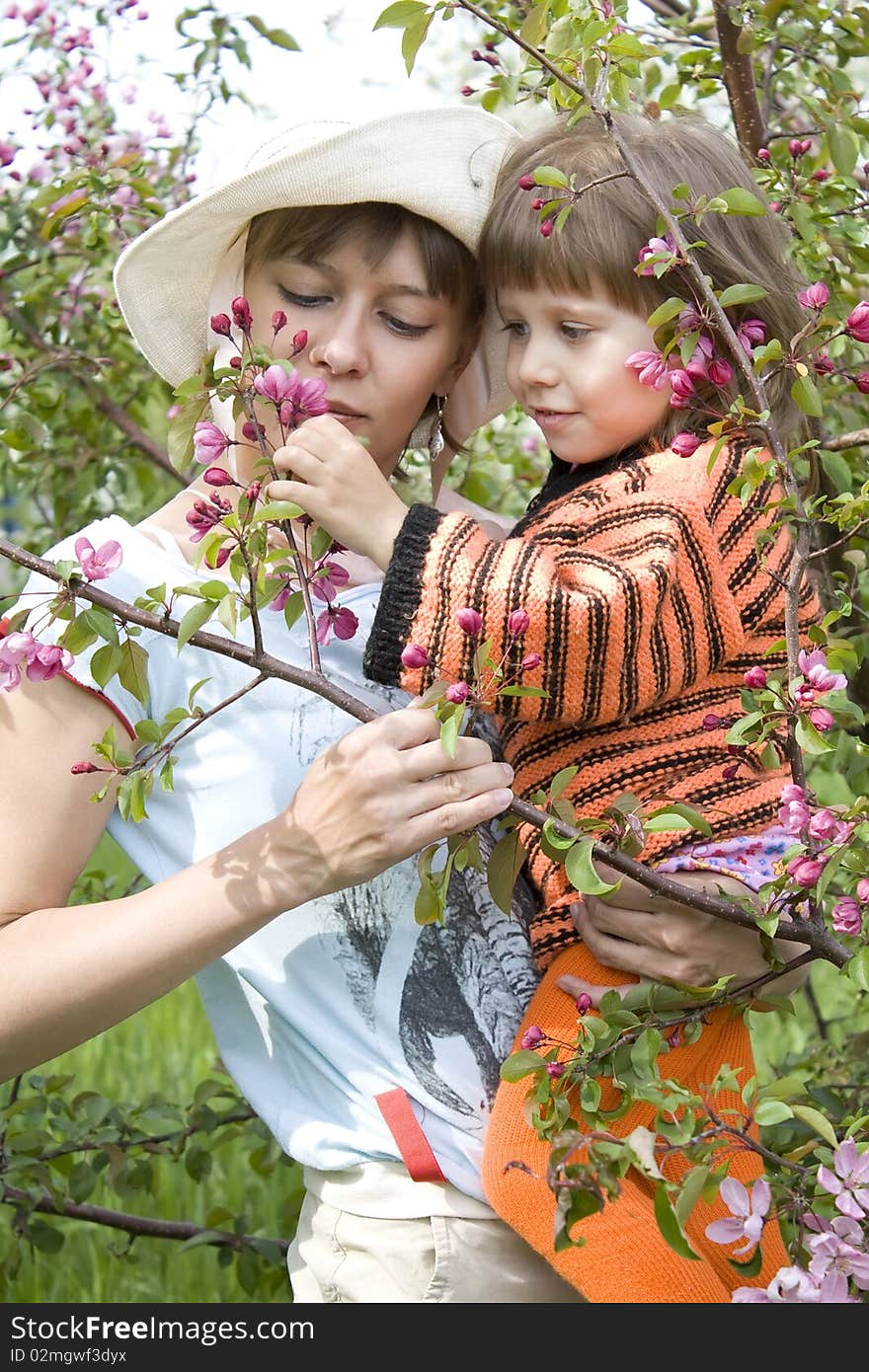 Mum And The Daughter With A Branch In Hands