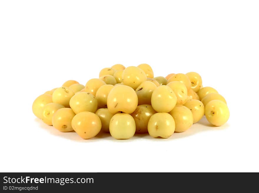 Heap of sweet yellow cherries isolated on white