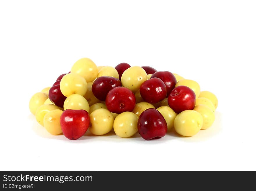 Heap of sweet red and yellow cherries isolated on white