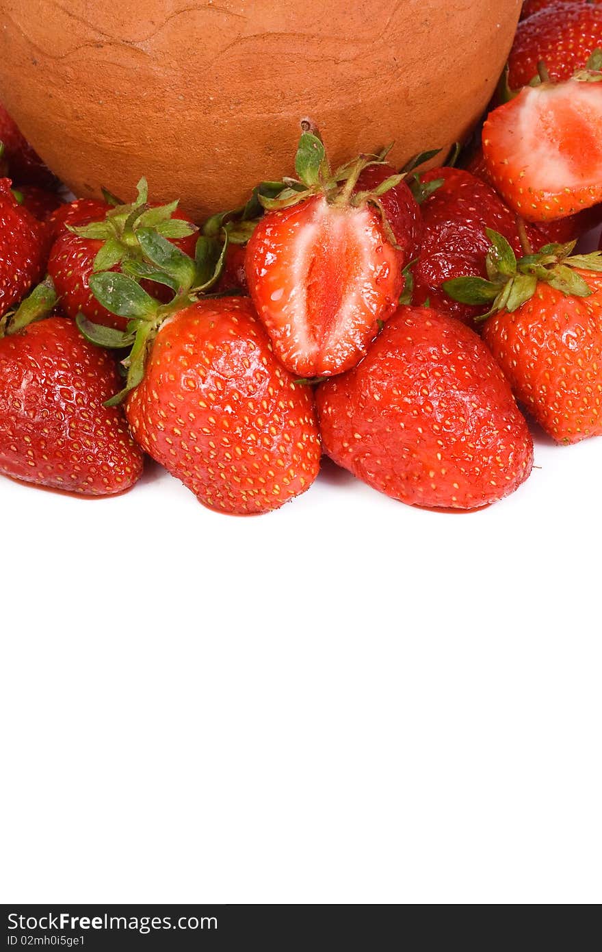 Ceramic pot and strawberry on white