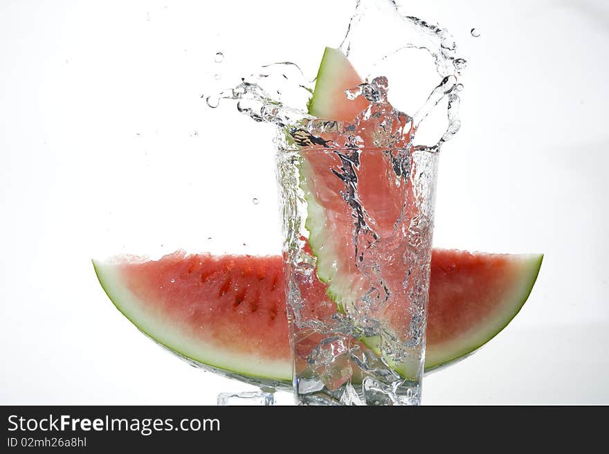 Water-melon falling on the clear water