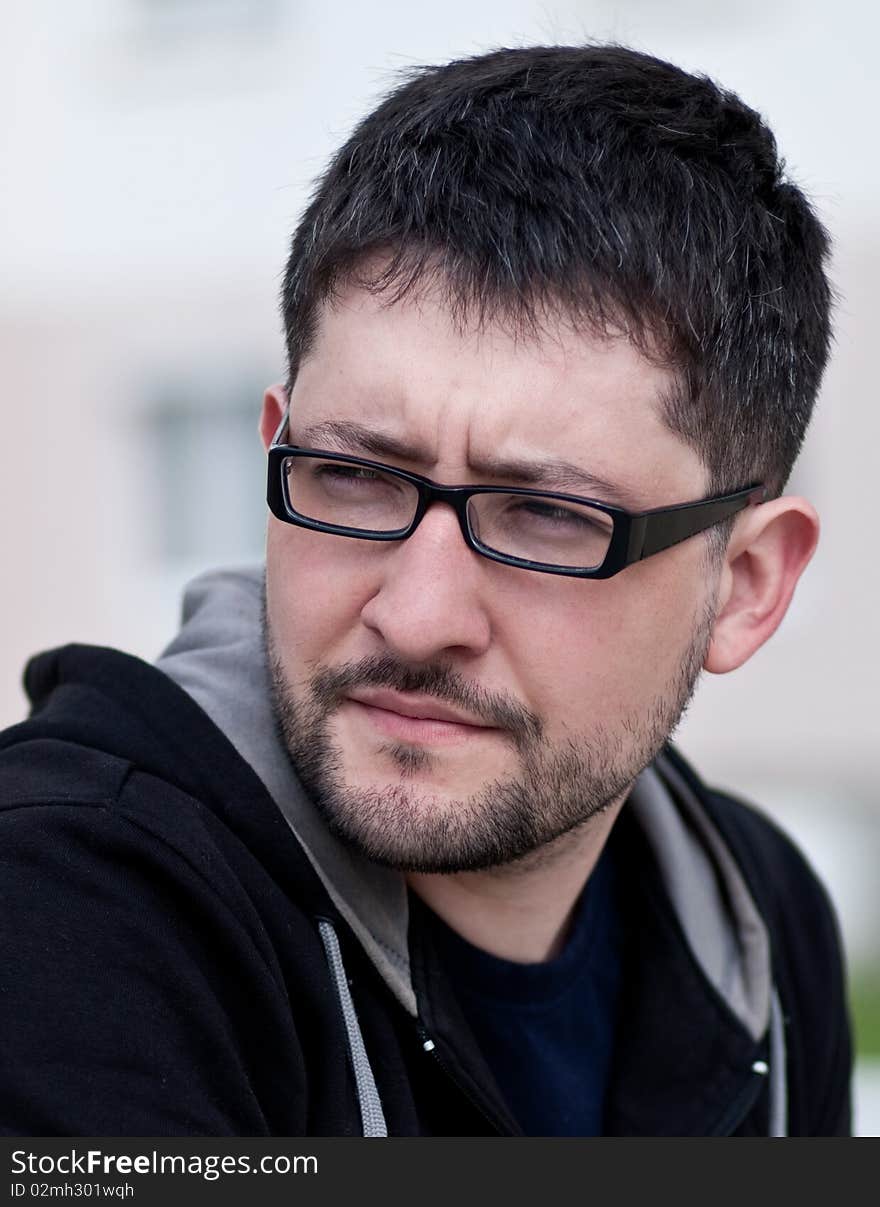 Portrait of a young bearded man wearing glasses