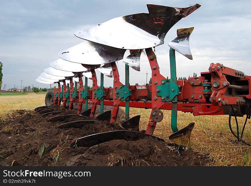 Plow with 7 shares and plowed land