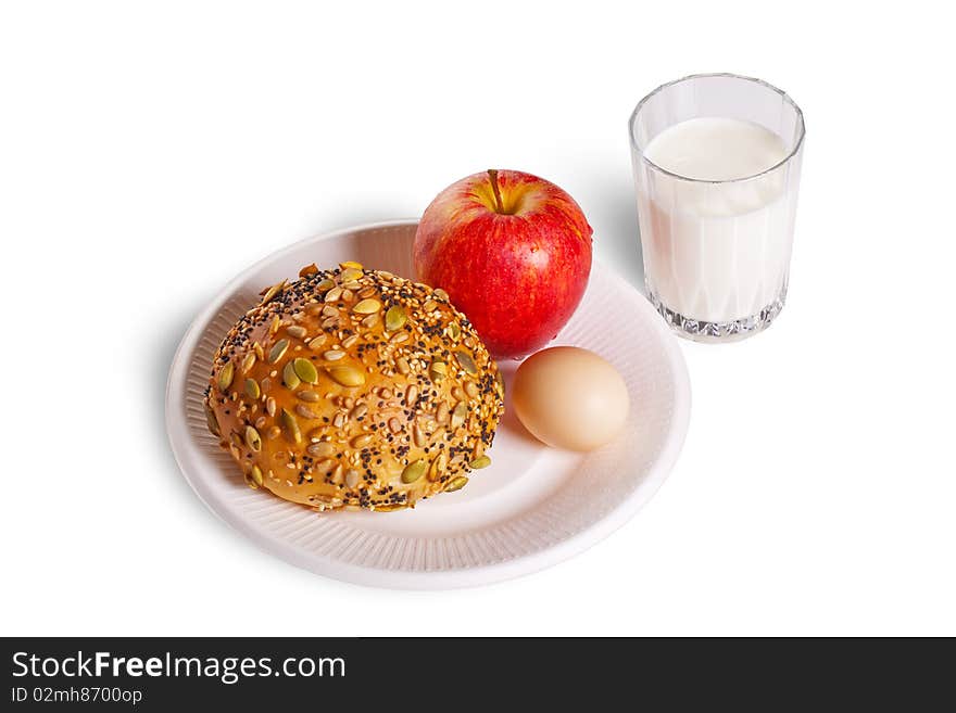 The healthy breakfast include bread, egg, apple and a cup of milk.