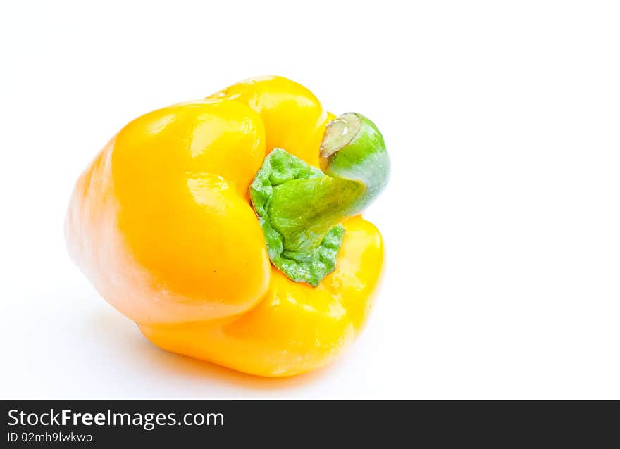 A yellow paprika on white background