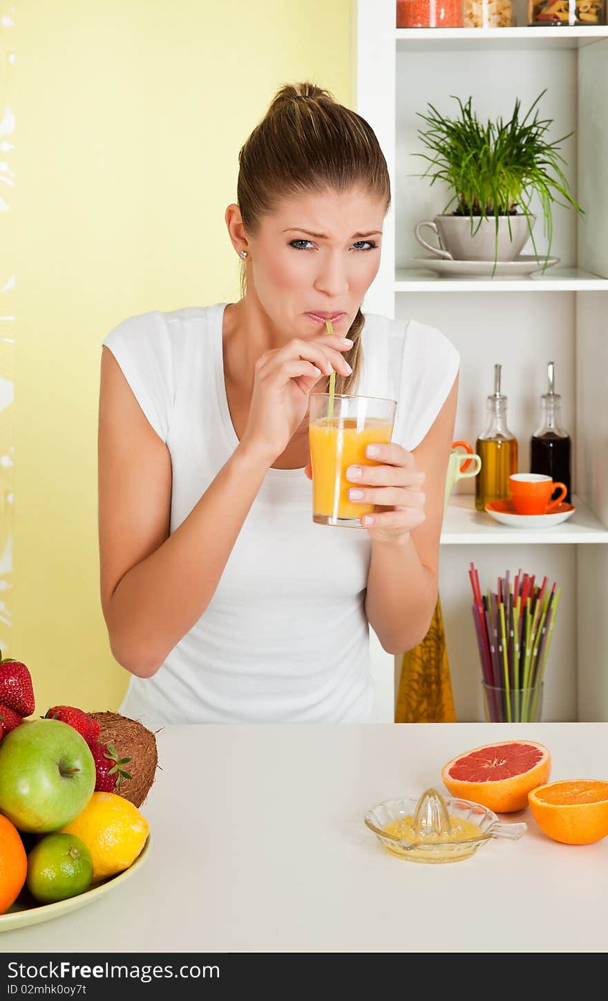 Beauty, young girl drinking acid orange juice at home